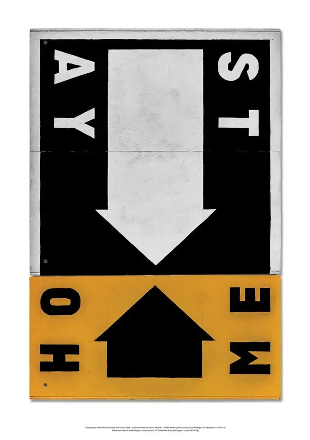 Two-panel graphic sign reading "STAY HOME" with arrows