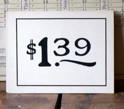 Hand-painted white wooden price sign reading $139 — vintage farmhouse decor
