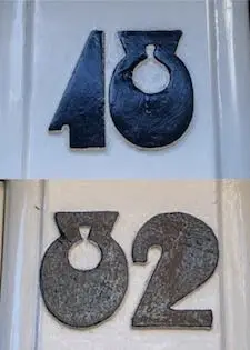 Two cast-metal house number sets — '40' (gloss) above '02' (weathered)