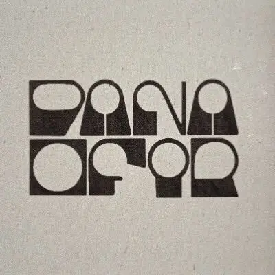 Geometric modular wordmark reading "PANAMA CAFE" on textured beige paper