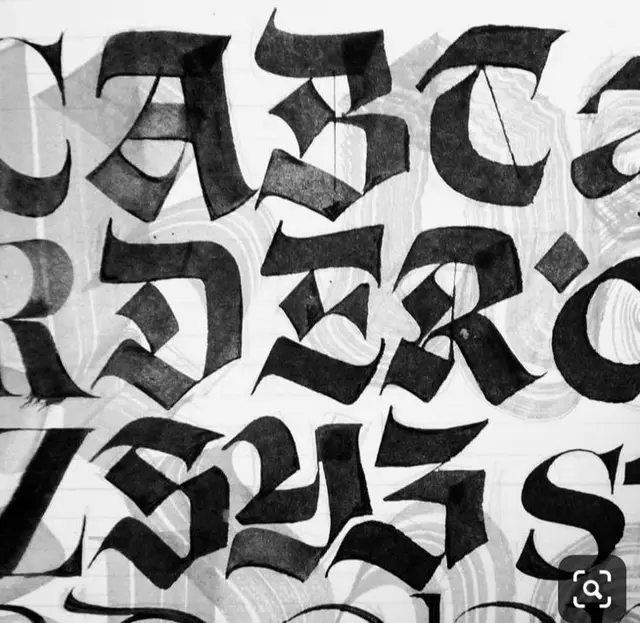 Blackletter (Gothic) alphabet study — brush-pen calligraphy on paper