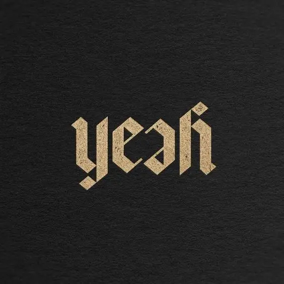 Gold Blackletter "yeah" Wordmark on Textured Black Paper