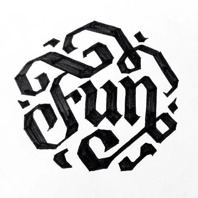 Hand-drawn blackletter calligraphy emblem on white paper