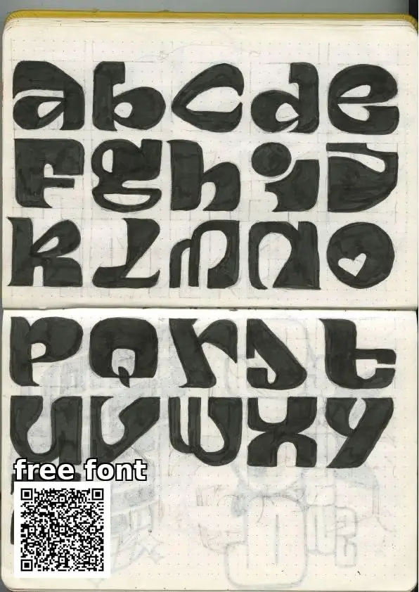 Hand-drawn chunky lowercase alphabet in dot-grid sketchbook