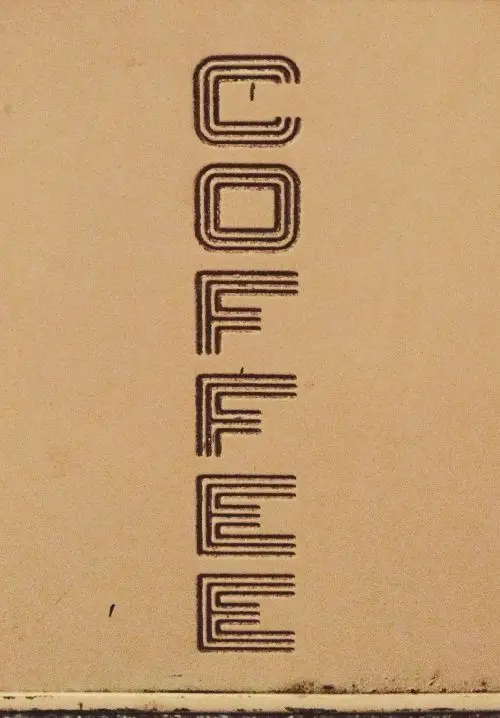 Vertical 'COFFEE' letterpress wordmark on kraft paper