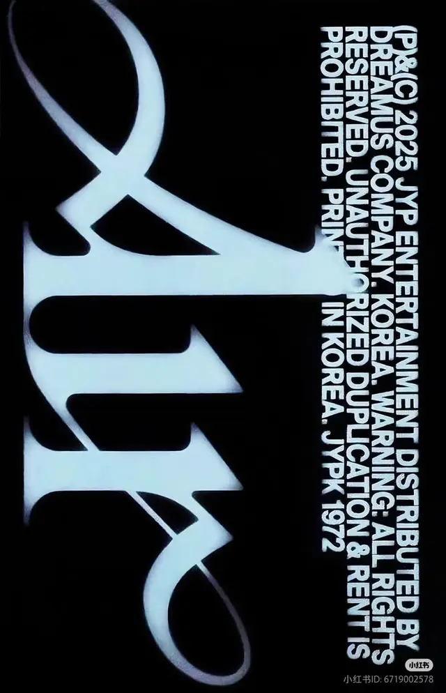 Vertical JYP Entertainment copyright stripe with oversized stylized white logo on black