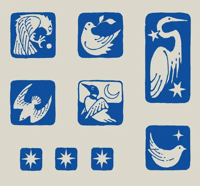 Blue linocut bird and star block prints on cream paper