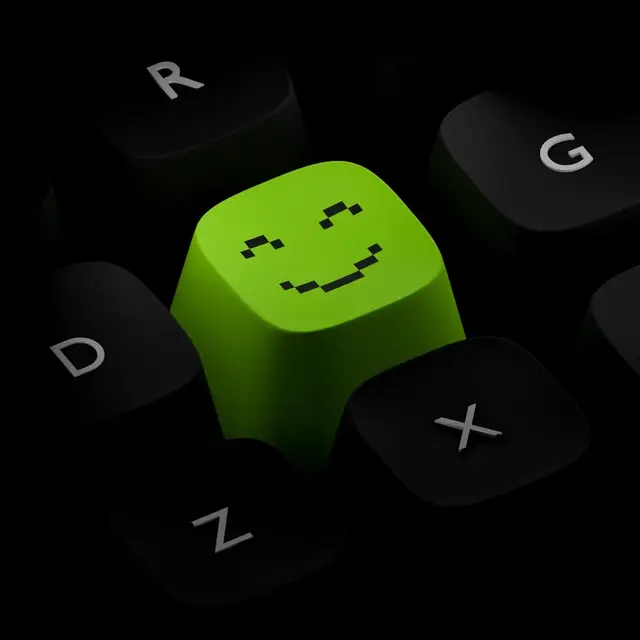 Lime-green pixel-smile artisan keycap on matte black mechanical keyboard