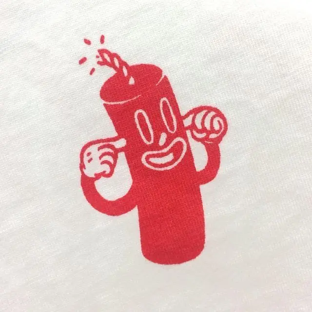 Red cartoon dynamite screen print on white T‑shirt