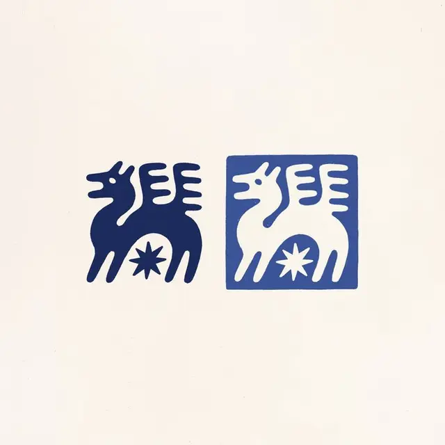 Paired block-print animal emblem — blue positive/negative study
