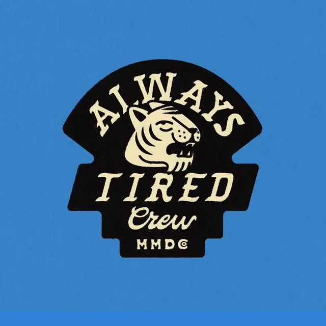 Always Tired Crew vintage tiger patch on blue background