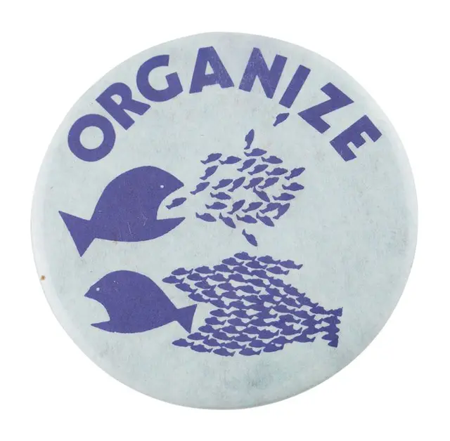 Vintage circular pinback button with 'ORGANIZE' and fish-silhouette graphic