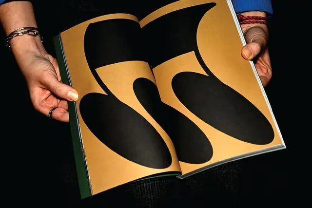 Editorial Spread — Black Biomorphic Shapes on Mustard Pages