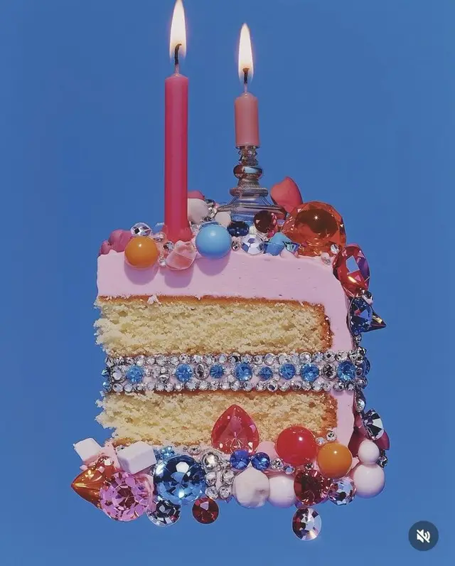 Pink-frosted two-layer cake slice with rhinestone band and crystal gems