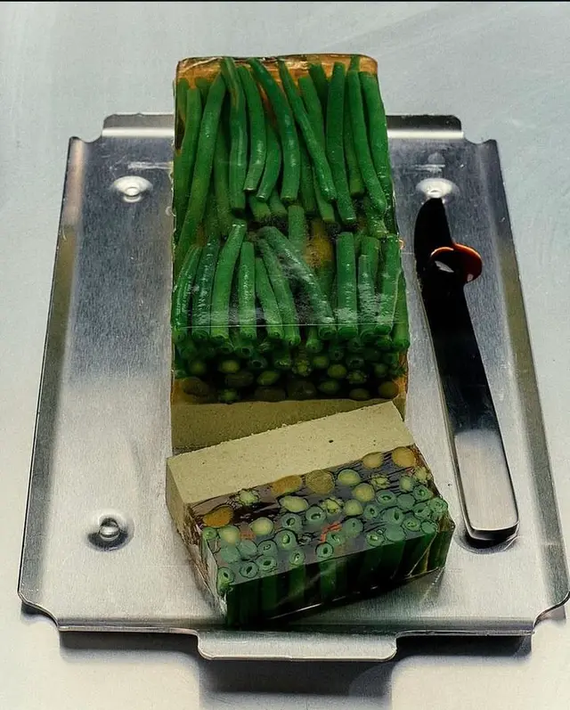 Green bean aspic terrine with pâté slice on stainless-steel tray