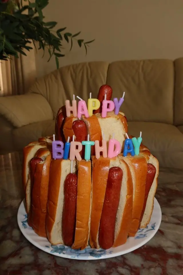 DIY hot‑dog and sliced bread birthday 'cake' with letter candles