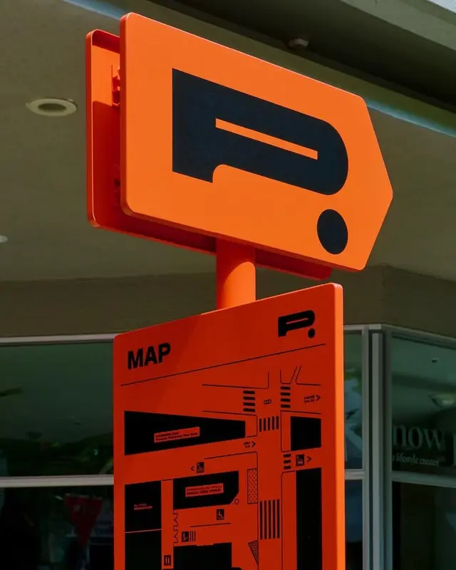 Orange parking wayfinding sign with map panel