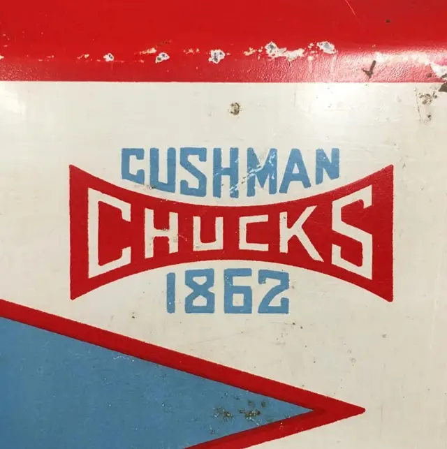 Weathered painted metal sign: "CUSHMAN CHUCKS 1862"