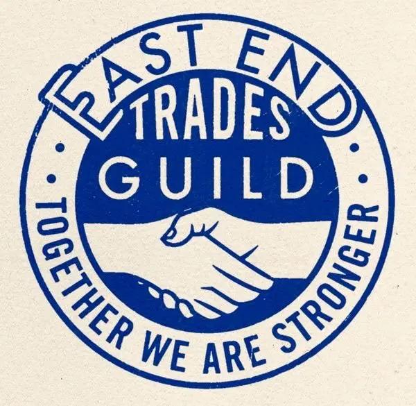 East End Trades Guild circular seal — vintage blue handshake emblem