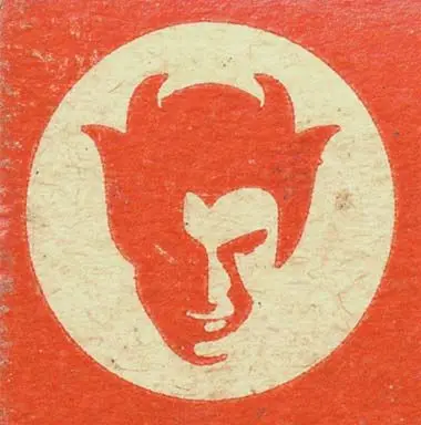 Vintage horned devil head emblem on aged paper
