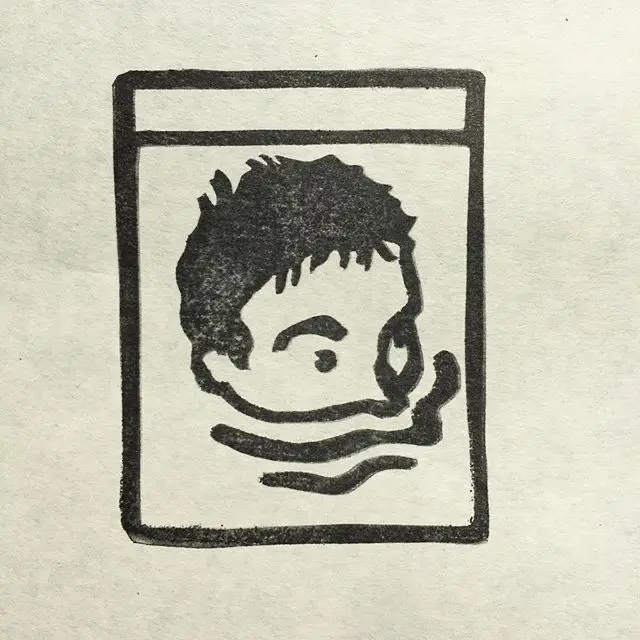Black ink block-print portrait in rectangular label