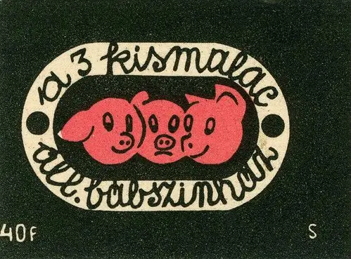 Vintage graphic emblem: three pink pig heads in cream oval with Hungarian script
