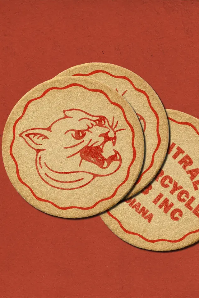 Stacked kraft paper coasters with red printed snarling cat logo