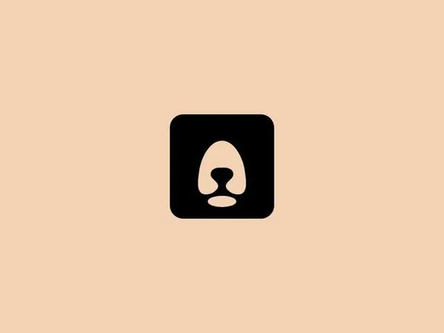 Minimal negative-space dog snout logo on peach background