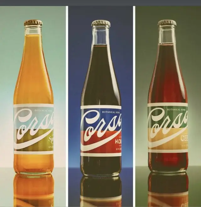 Triptych of glass 'Corsa' botanical soda bottles with script labels