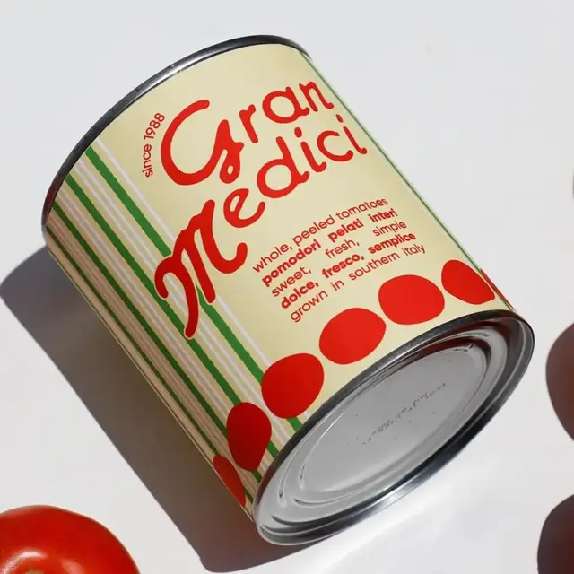 Gran Medici canned tomatoes — cream label with green stripes and red tomato icons