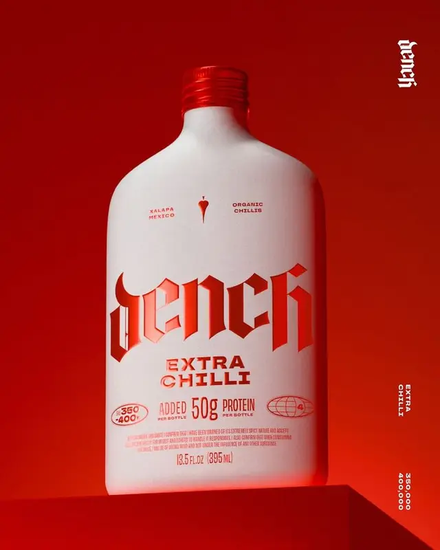 Dench Extra Chilli matte white bottle with red blackletter logo