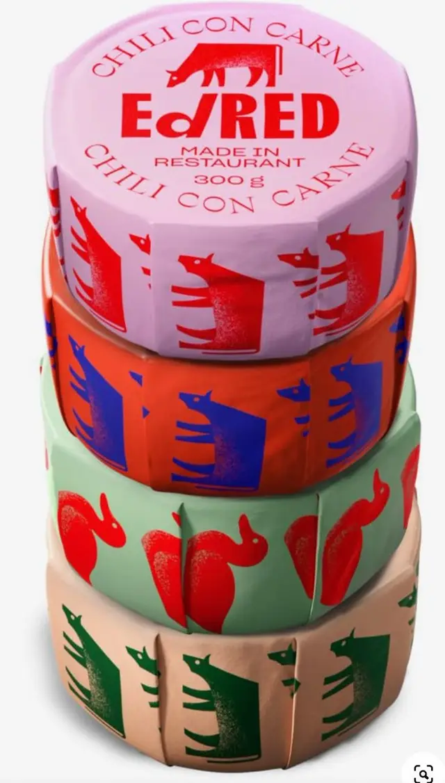 Stacked round food tins with screen-printed animal wrappers — "Chilli con Carne" label