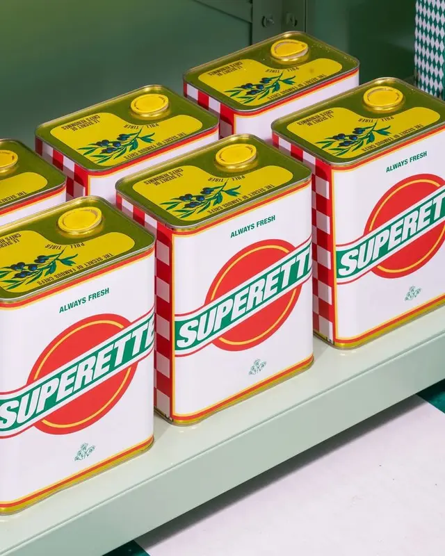 SUPERETTE metal tins with olive illustration on pale green shelf