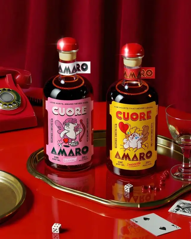 Cuore Amaro bottles with retro cartoon labels on glossy red bar tray