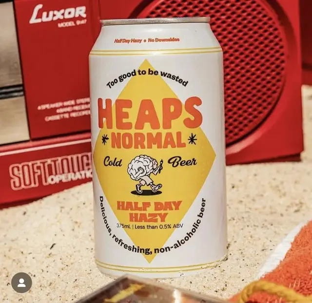 HEAPS NORMAL ‘Half Day Hazy’ non-alcoholic beer can — white can with yellow diamond and br