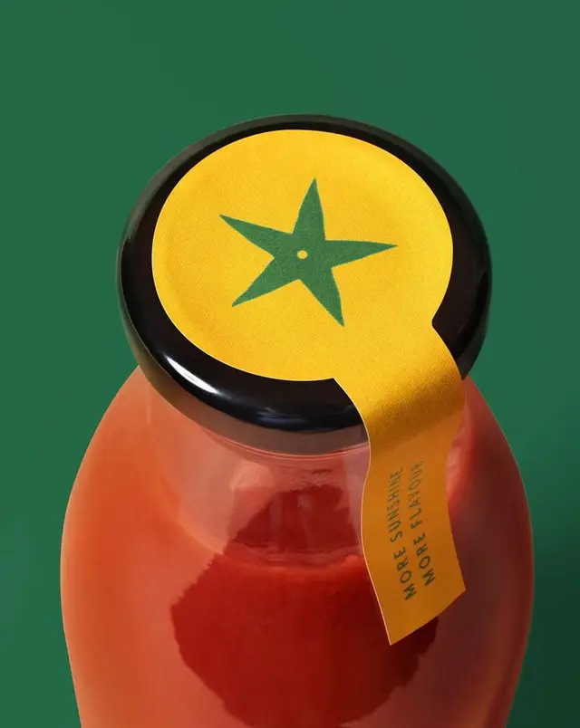 Glass bottle with yellow circular tamper seal and green star