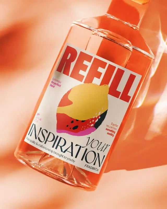 Close-up glass bottle with bold 'REFILL' label and colorful fruit illustration