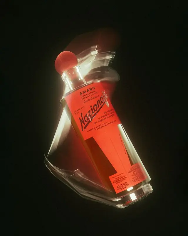 Nazionale Amaro — red-label glass bottle floating on black background