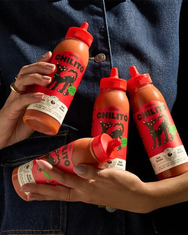 Chilito red squeeze sauce bottles with black dog logo