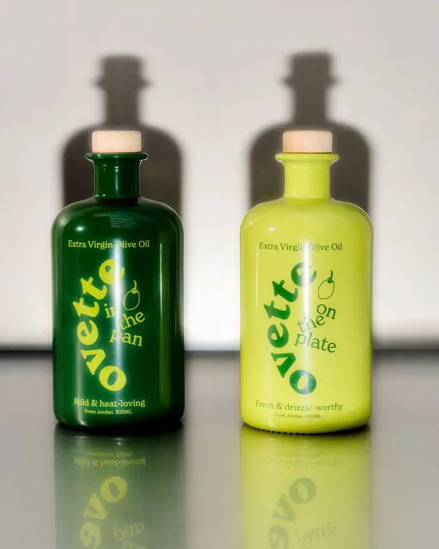 Pair of Extra Virgin Olive Oil Bottles — dark green and chartreuse ceramic bottles with c​