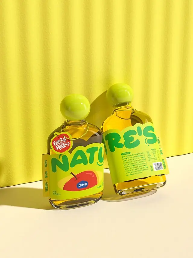 Two glass bottles with lime-green 'NATURE'S' apple labels