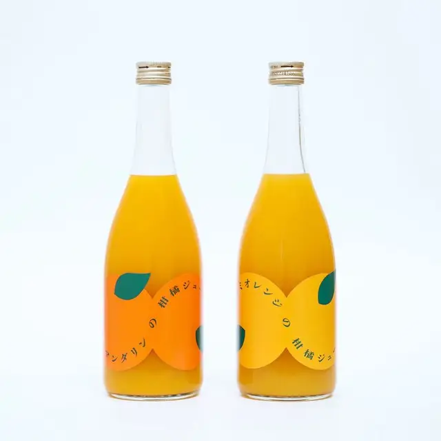 Minimalist orange juice packaging — die-cut orange-shaped labels on clear glass bottles