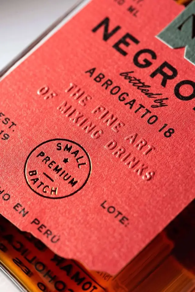 Red embossed liquor label with circular "Small Premium Batch" stamp