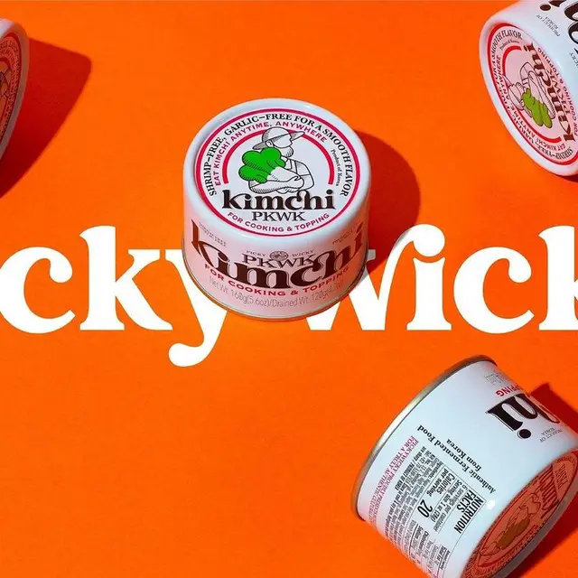 Kimchi tin packaging — flat‑lay product photo on vivid orange background