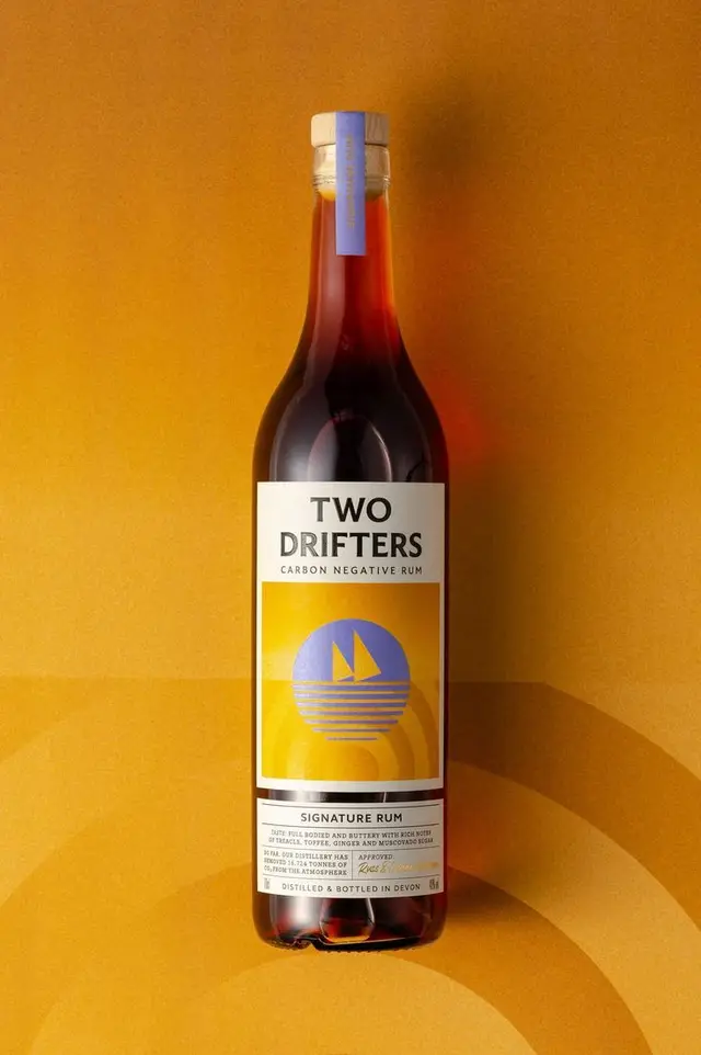 Two Drifters Carbon Negative Rum — amber bottle with sailboat label