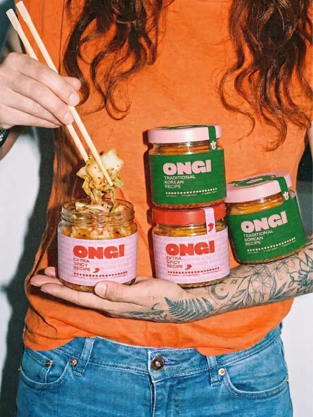 ONGI kimchi jars held by tattooed arm — pink & green labeled condiments