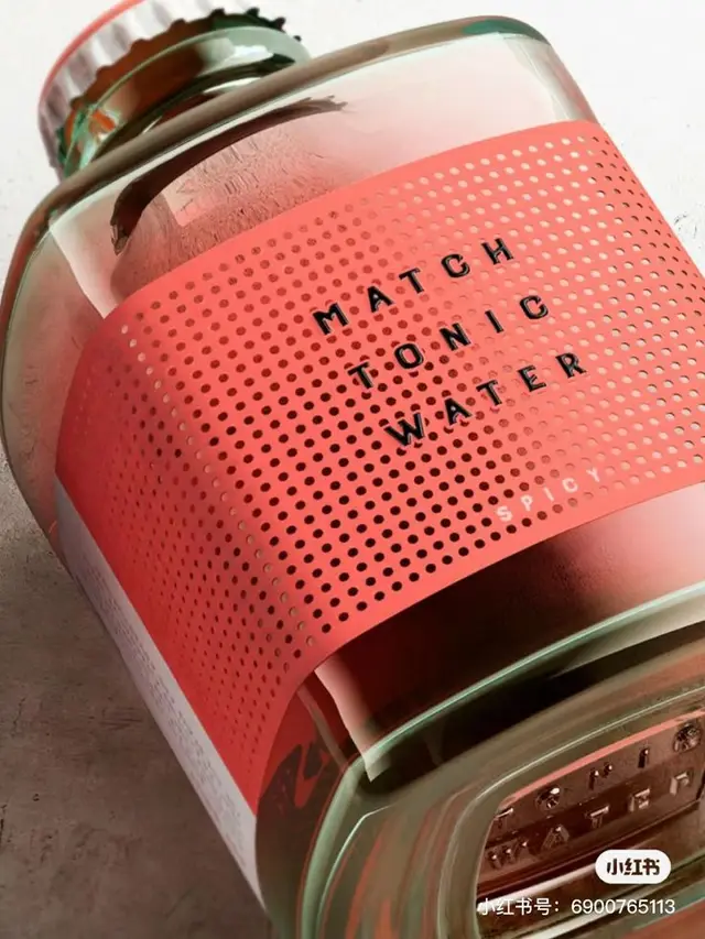 Coral perforated wrap label on glass tonic water bottle — "MATCH TONIC WATER"