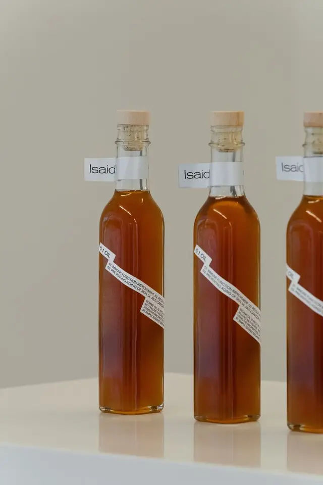 Minimalist glass bottles with cork stoppers and 'Isaid' neck labels