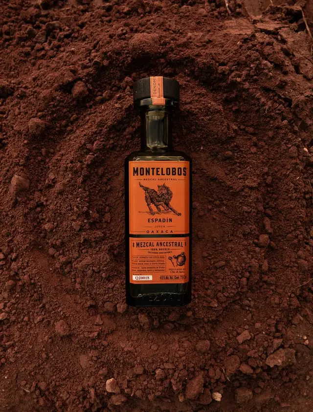 Montelobos Espadín mezcal bottle on red volcanic soil