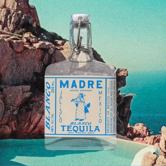 MADRE Blanco tequila bottle over turquoise coastal cliffs — vintage label mockup